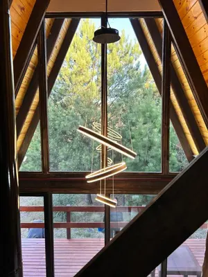 a chandelier hanging from the ceiling of a cabin at Aire Escondido in Villa Berna