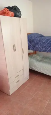 a small cabinet next to a bunk bed at Hospedaje Miraflor in Cerro de Oro