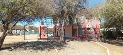 a swing set in front of a house at Hospedaje Miraflor in Cerro de Oro