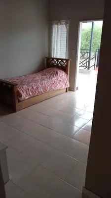 a bedroom with a bed and a tiled floor at Hospedaje Miraflor in Cerro de Oro