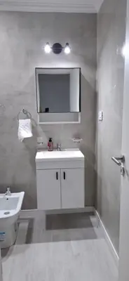 a bathroom with a white sink and a mirror at Miralejos 16 Turquesa in Villa Carlos Paz
