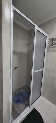 a shower with a glass door in a bathroom at Miralejos 16 Turquesa in Villa Carlos Paz