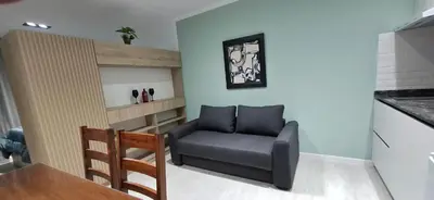a living room with a chair and a table at Miralejos 16 Turquesa in Villa Carlos Paz