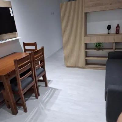 a dining room with a wooden table and chairs at Miralejos 16 Turquesa in Villa Carlos Paz