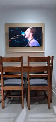 a tv sitting on a wall with two chairs at Miralejos 16 Turquesa in Villa Carlos Paz