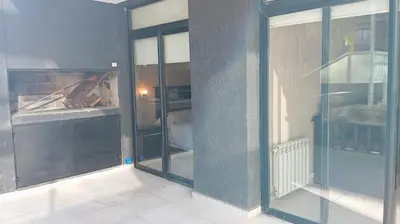 an empty room with glass doors in a room at Dpto Premium Costanera Pileta y Cochera in Villa Carlos Paz