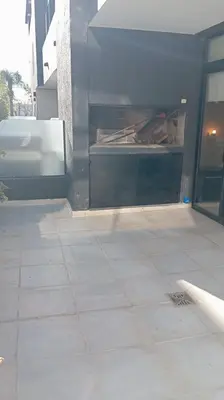 a building with an open door on a sidewalk at Dpto Premium Costanera Pileta y Cochera in Villa Carlos Paz
