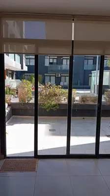 a view of a building through a glass window at Dpto Premium Costanera Pileta y Cochera in Villa Carlos Paz