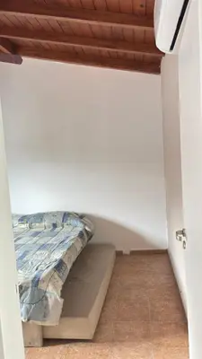 a room with a bed in the corner of a room at Departamento Carlos Paz cerca Centro y Río in Villa Carlos Paz
