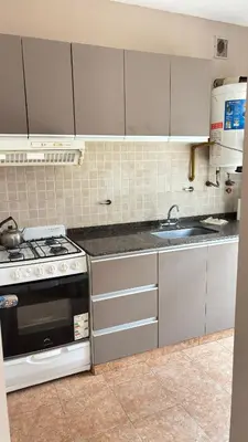 a kitchen with a stove and a sink at Departamento Carlos Paz cerca Centro y Río in Villa Carlos Paz