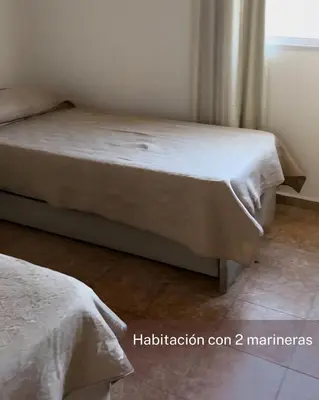 a bedroom with two beds and a window at Departamento Carlos Paz cerca Centro y Río in Villa Carlos Paz