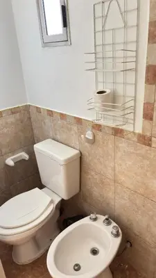a bathroom with a toilet and a sink at Departamento Carlos Paz cerca Centro y Río in Villa Carlos Paz