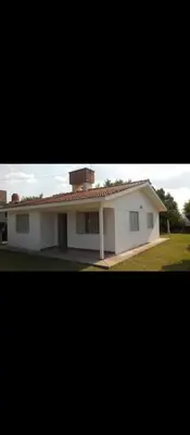 a white house with a red roof at La casa de los Nonos in Mina Clavero