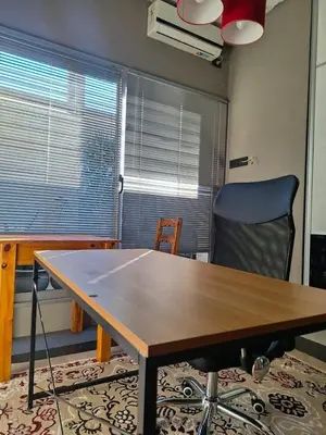 a wooden table and a chair in a room at Modern PH with Grill in Cordoba