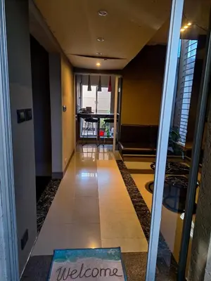 a hallway with a welcome mat on the floor at Modern PH with Grill in Cordoba