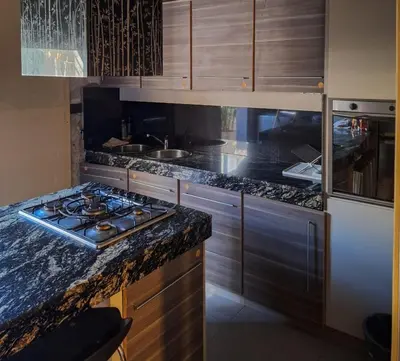 a kitchen with a stove and a counter top at Modern PH with Grill in Cordoba