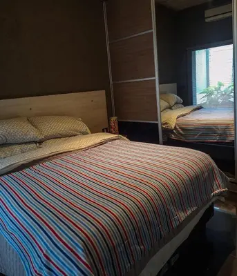a bedroom with two beds and a mirror at Modern PH with Grill in Cordoba