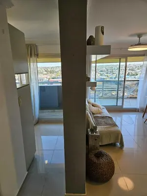 a bedroom with a bed and a large window at Hermoso Departamento tipo Duplex en piso 17y18 in Cordoba