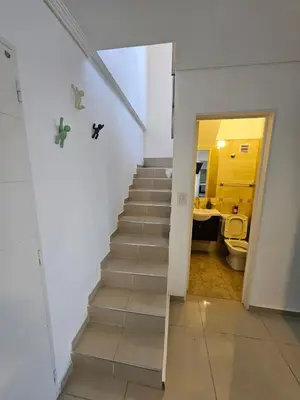 a staircase in a room with a bathroom and a toilet at Hermoso Departamento tipo Duplex en piso 17y18 in Cordoba