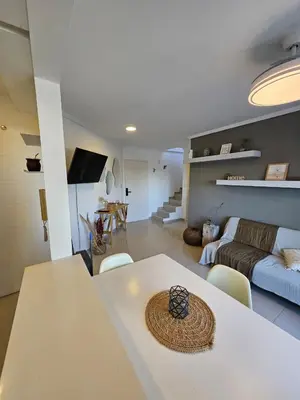 a living room with a table and a couch at Hermoso Departamento tipo Duplex en piso 17y18 in Cordoba