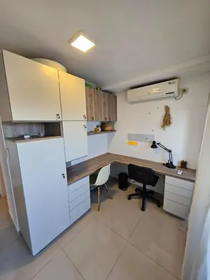 a kitchen with a desk and a refrigerator at Hermoso Departamento tipo Duplex en piso 17y18 in Cordoba