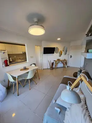 a living room with a couch and a table at Hermoso Departamento tipo Duplex en piso 17y18 in Cordoba