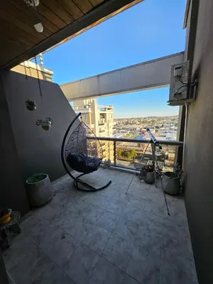 a balcony with a hammock on the floor of a building at Hermoso Departamento tipo Duplex en piso 17y18 in Cordoba