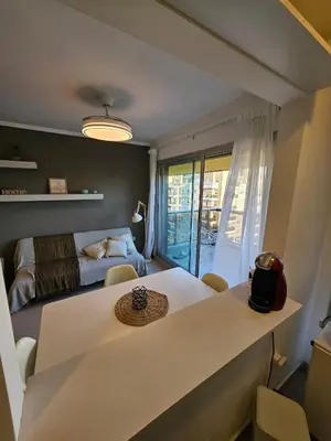 a room with a table and a bed and a bedroom at Hermoso Departamento tipo Duplex en piso 17y18 in Cordoba
