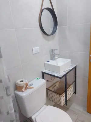 a bathroom with a toilet and a sink at Tiny House Potrero Cba in Potrero de Garay