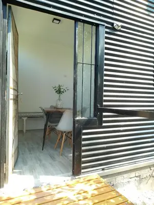 an open door to a room with a table at Tiny House Potrero Cba in Potrero de Garay