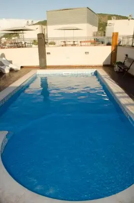 a large pool of blue water in front of a building at Departamento Céntrico Miralejos 3 in Villa Carlos Paz