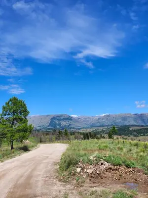 a dirt road with mountains in the distance at Brisas de la Cayana Cabaña Villa Alpina in Villa Alpina