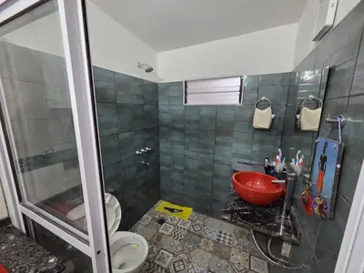 a bathroom with a red sink and a shower at Lusanyun in Villa Carlos Paz