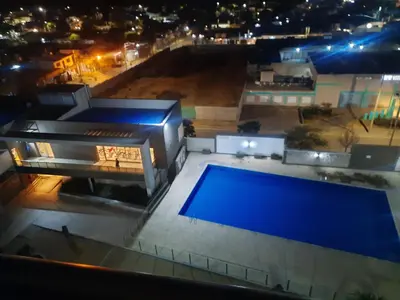 a view of a house with a swimming pool at night at Terra Zion in Cordoba