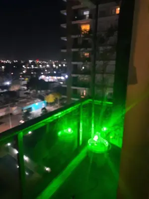 a room with green lights on a balcony at night at Terra Zion in Cordoba
