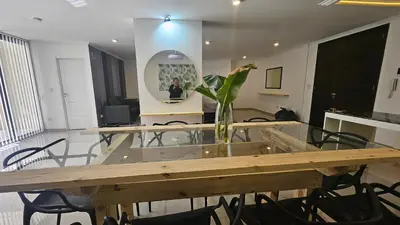a room with a table with a vase with flowers on it at Semipiso CALAZANS in Cordoba