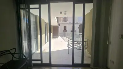 an open door to a balcony with a table at Semipiso CALAZANS in Cordoba