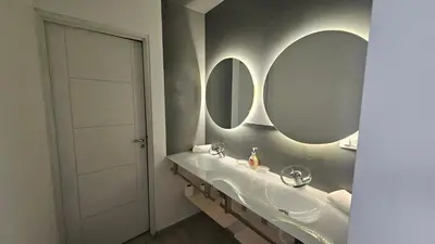 a bathroom with a sink and two mirrors on the wall at Semipiso CALAZANS in Cordoba