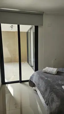a bedroom with a bed and a large window at Semipiso CALAZANS in Cordoba