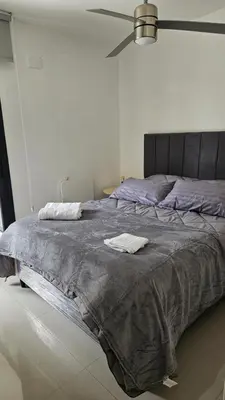 a bedroom with a large bed with two towels on it at Semipiso CALAZANS in Cordoba