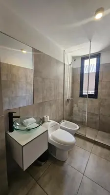 a bathroom with a toilet and a sink and a shower at Semipiso CALAZANS in Cordoba