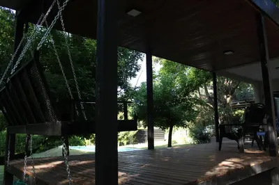 a porch of a house with a swing at Rocio del Champaqui in Santa Rosa de Calamuchita