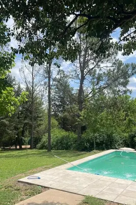 a small swimming pool in a park with trees at Rocio del Champaqui in Santa Rosa de Calamuchita
