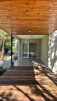 a porch with a wooden deck with a wooden ceiling at Rocio del Champaqui in Santa Rosa de Calamuchita
