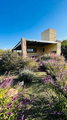 a house on the side of a hill with flowers at Finca La Linda in San Javier