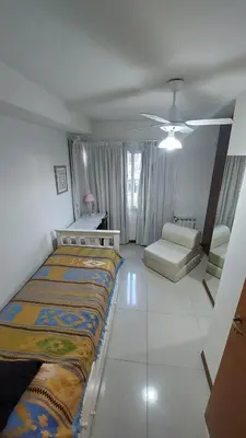 a bedroom with a large bed and a living room at Departamento Céntrico Miralejos 2 in Villa Carlos Paz