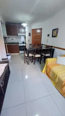 a living room with a bed and a dining room at Departamento Céntrico Miralejos 2 in Villa Carlos Paz