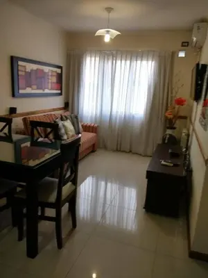 a living room with a table and a couch at Departamento Céntrico Miralejos 2 in Villa Carlos Paz