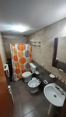a bathroom with two toilets and a shower curtain at Departamento Céntrico Miralejos 2 in Villa Carlos Paz