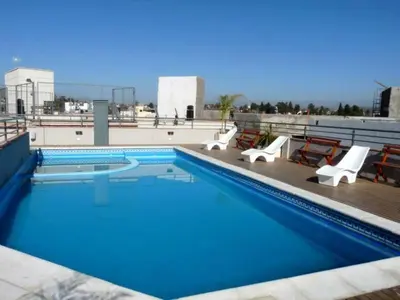 a swimming pool on the roof of a building at Departamento Céntrico Miralejos 2 in Villa Carlos Paz